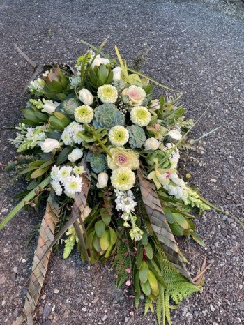 Casket spray in the natutal white and greens
